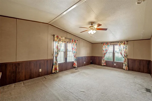 a bathroom with a granite countertop double vanity sink a mirror and a shower