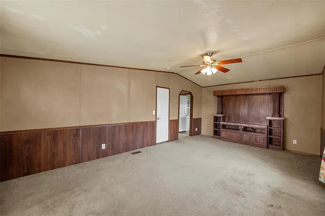 a view of a kitchen with wooden floor and electronic appliances