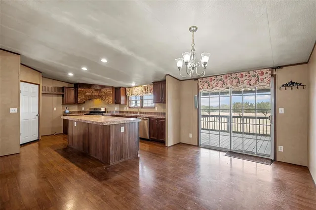 a view of a kitchen with a sink and a refrigerator