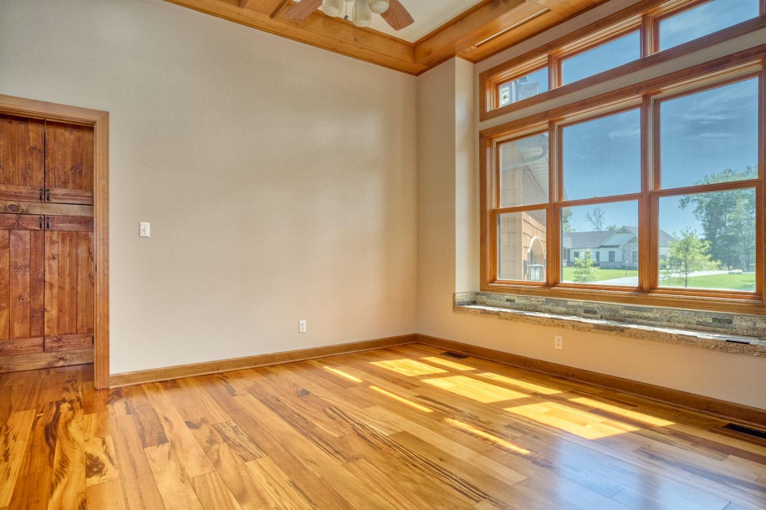8468 Old Oak Drive Demotte, IN 46310 - Photo 16 of 35 a view of an empty room with a window and wooden floor