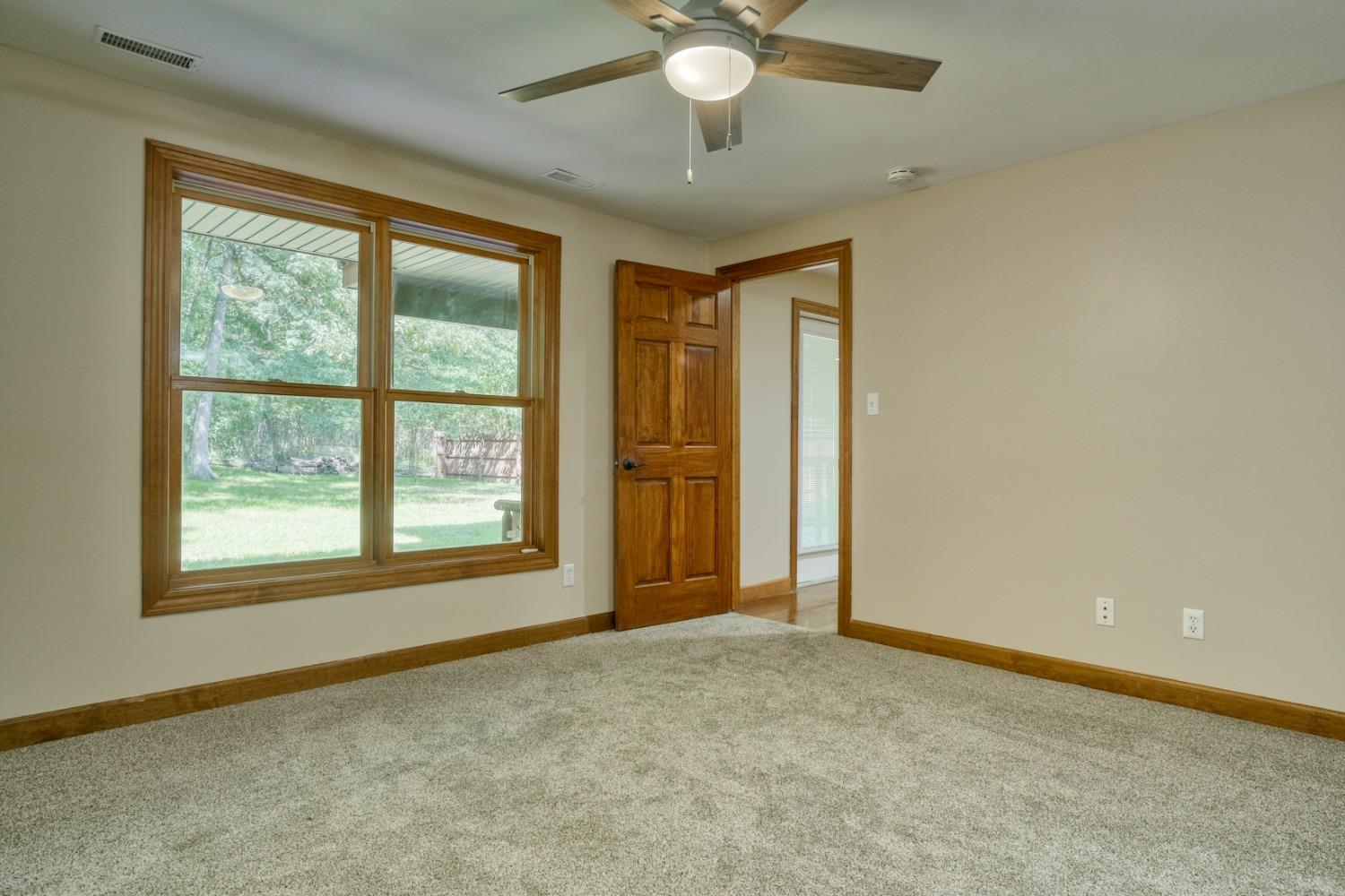8468 Old Oak Drive Demotte, IN 46310 - Photo 29 of 35 an empty room with chandelier fan and windows