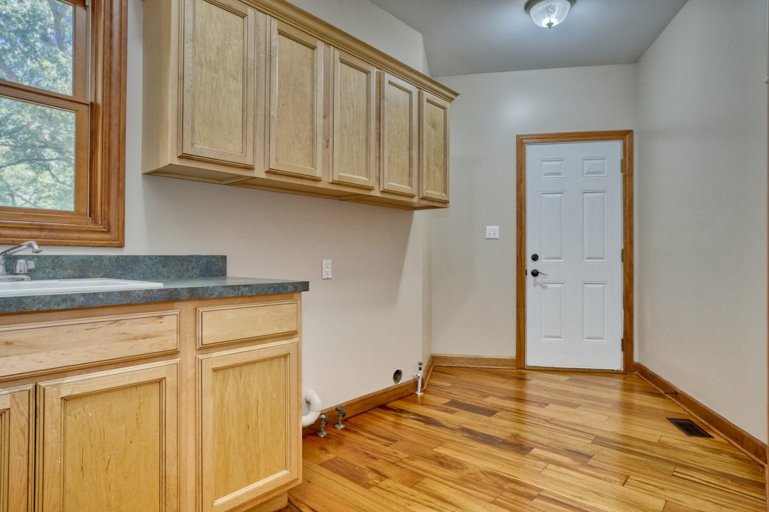 8468 Old Oak Drive Demotte, IN 46310 - Photo 32 of 35 a view of a kitchen with wooden floor and cabinets