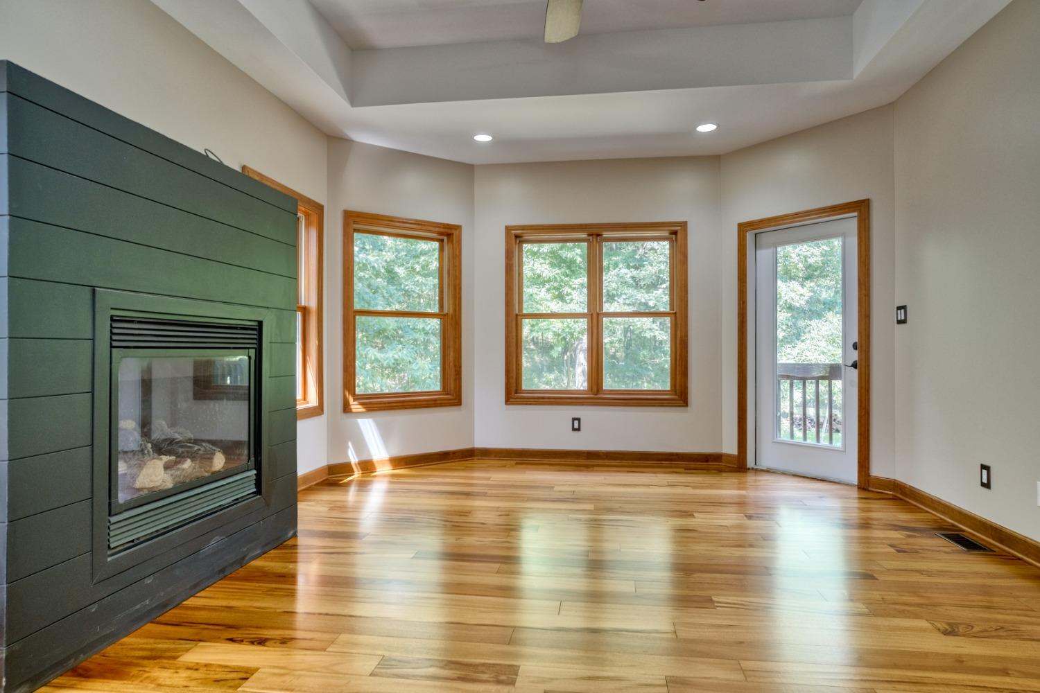 8468 Old Oak Drive Demotte, IN 46310 - Photo 10 of 35 a view of an empty room with window and wooden floor