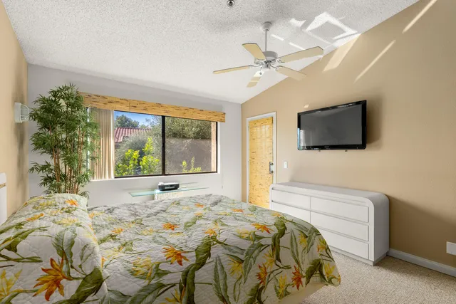 a bedroom with a bed and a painting on the wall