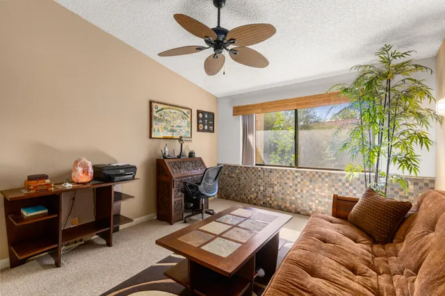 a living room with furniture and a rug