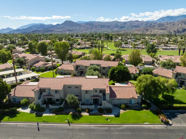 a view of a swimming pool and lounge chairs