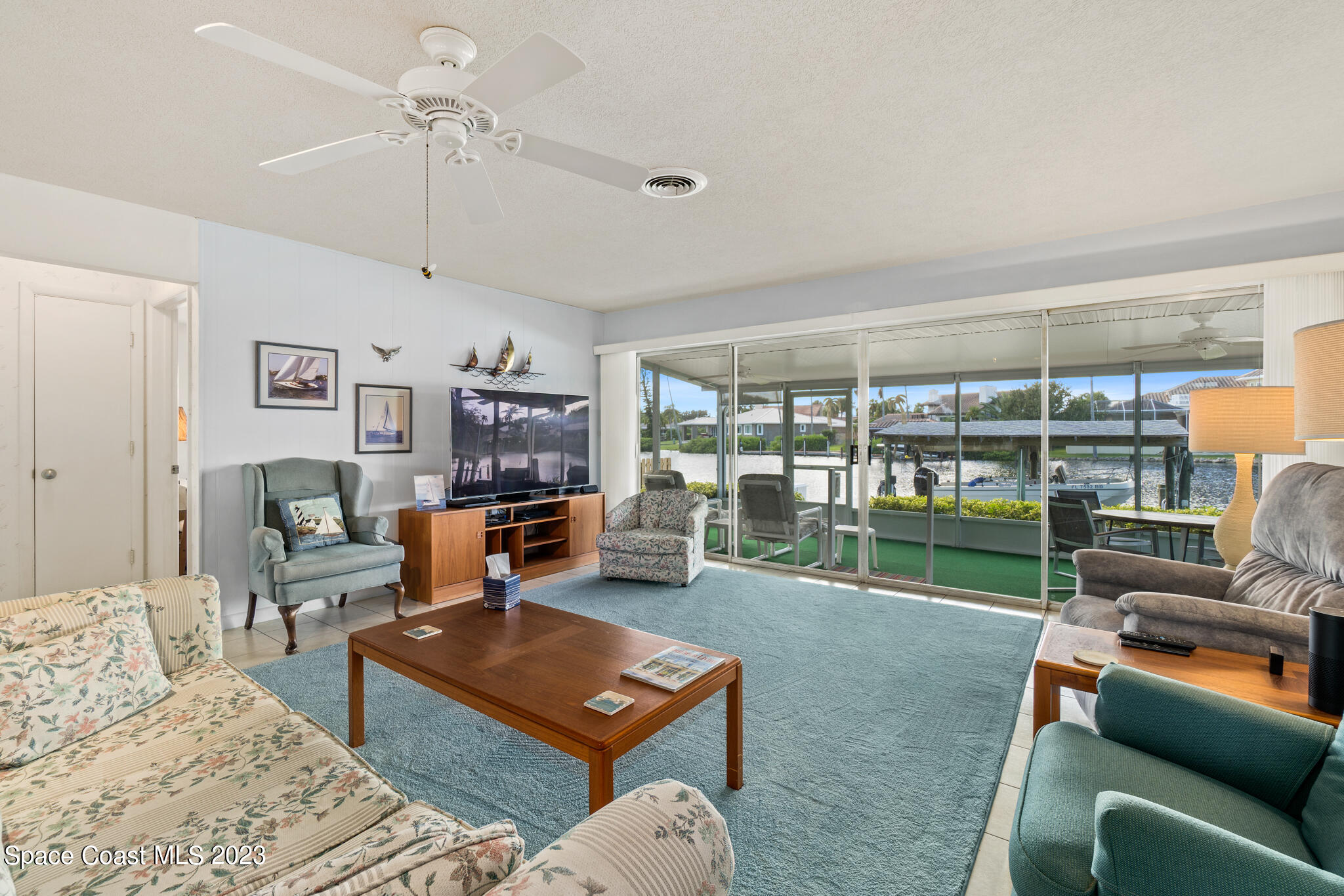 209 River Road Satellite Beach, FL 32937 - Photo 12 of 86 a living room with furniture a fireplace and a flat screen tv