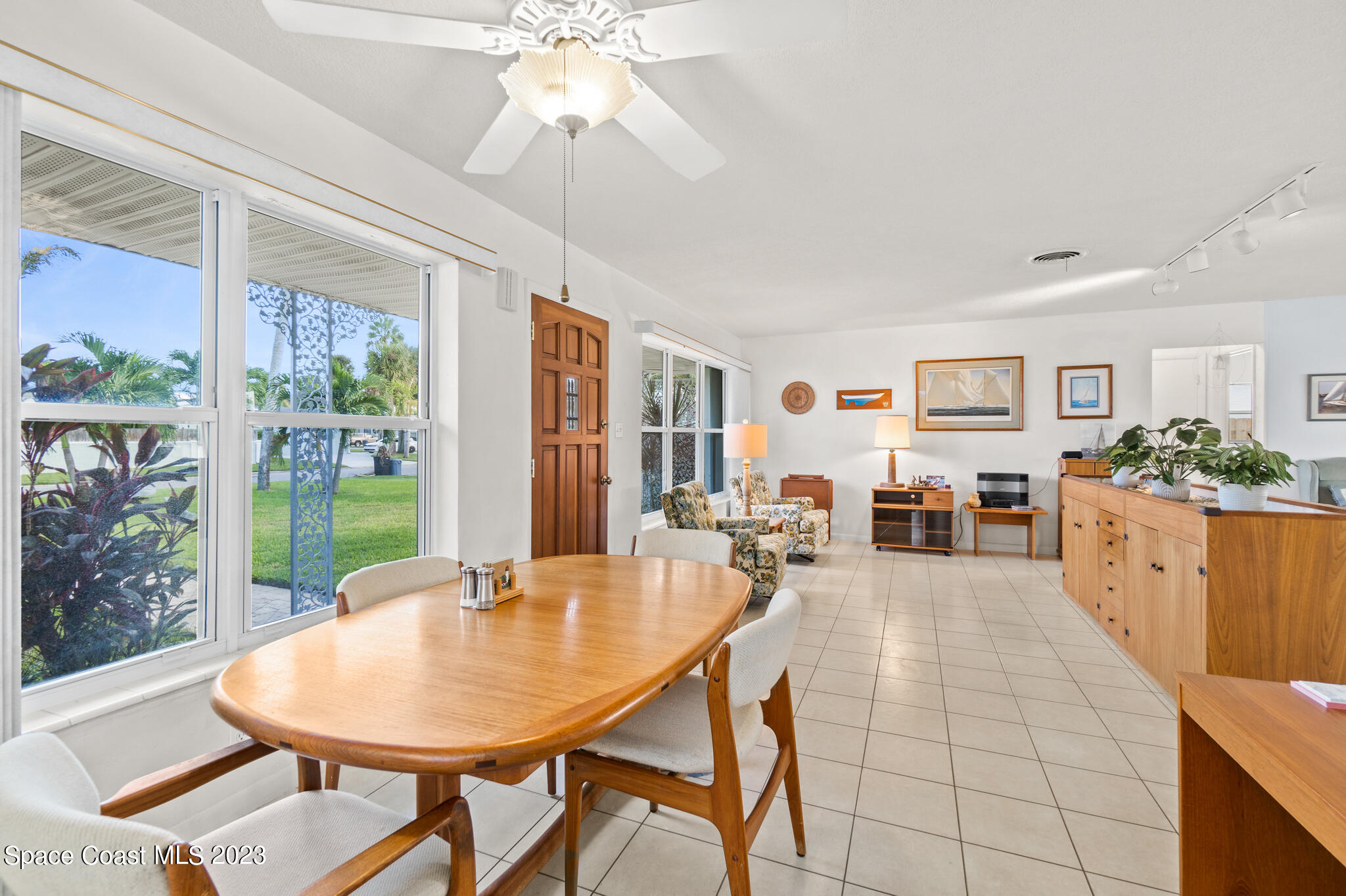209 River Road Satellite Beach, FL 32937 - Photo 16 of 86 a living room with furniture a chandelier and a dining table