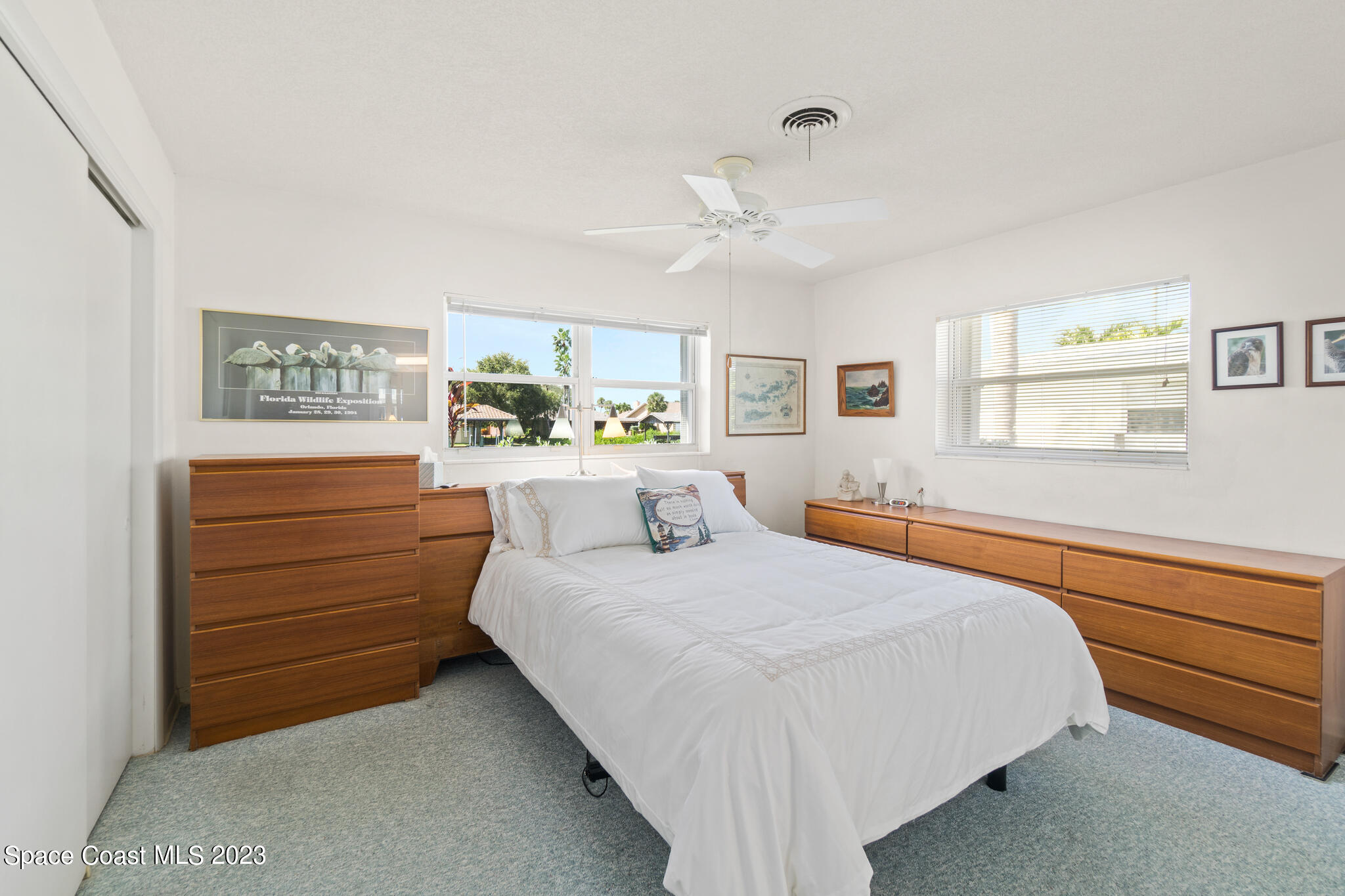 209 River Road Satellite Beach, FL 32937 - Photo 18 of 86 a bedroom with a bed and a dresser