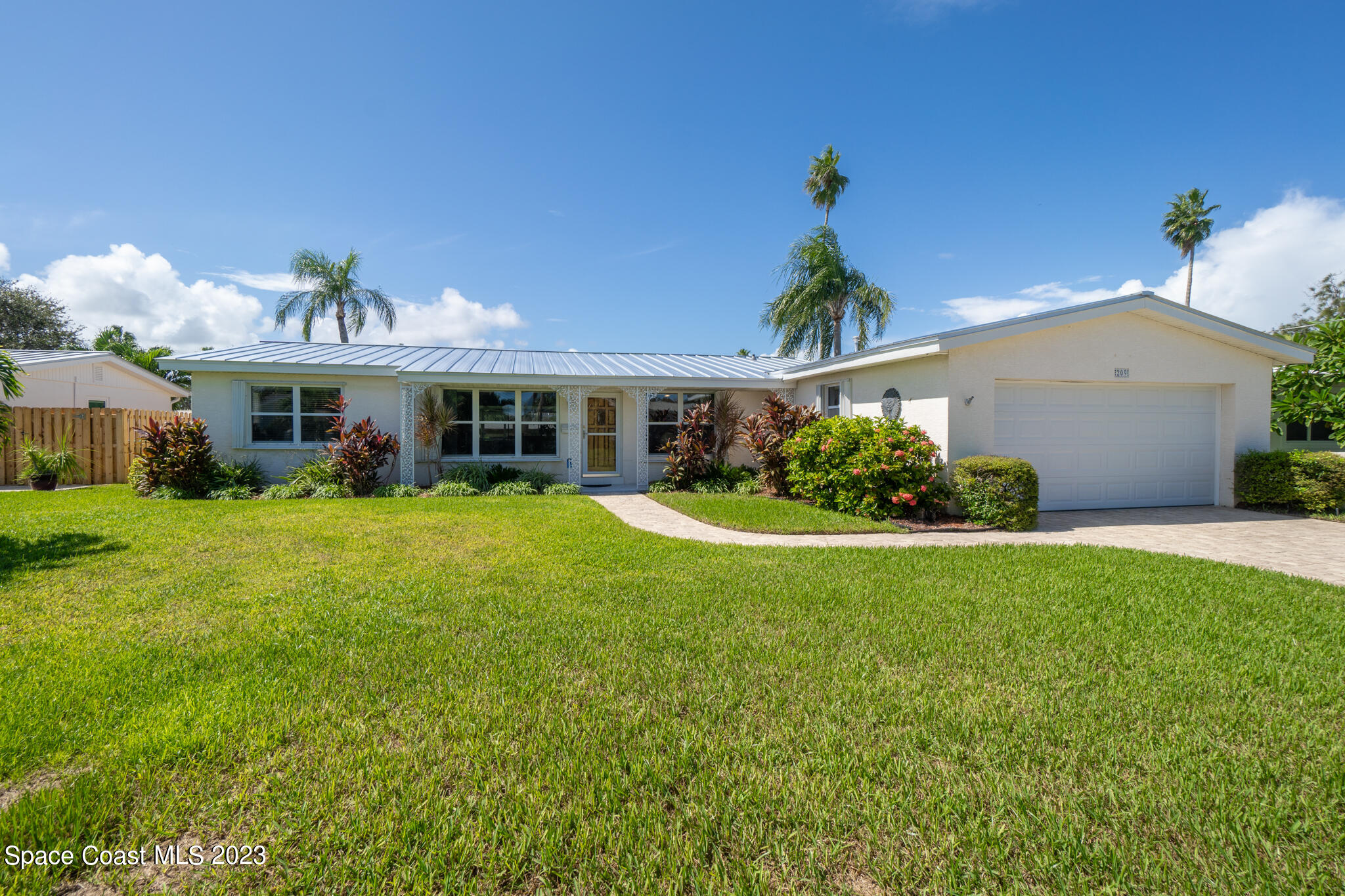 209 River Road Satellite Beach, FL 32937 - Photo 27 of 86 a front view of a house with a yard