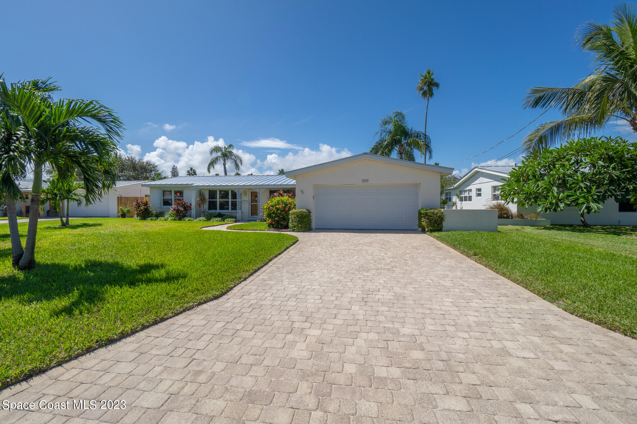 209 River Road Satellite Beach, FL 32937 - Photo 30 of 86 a front view of a house with garden