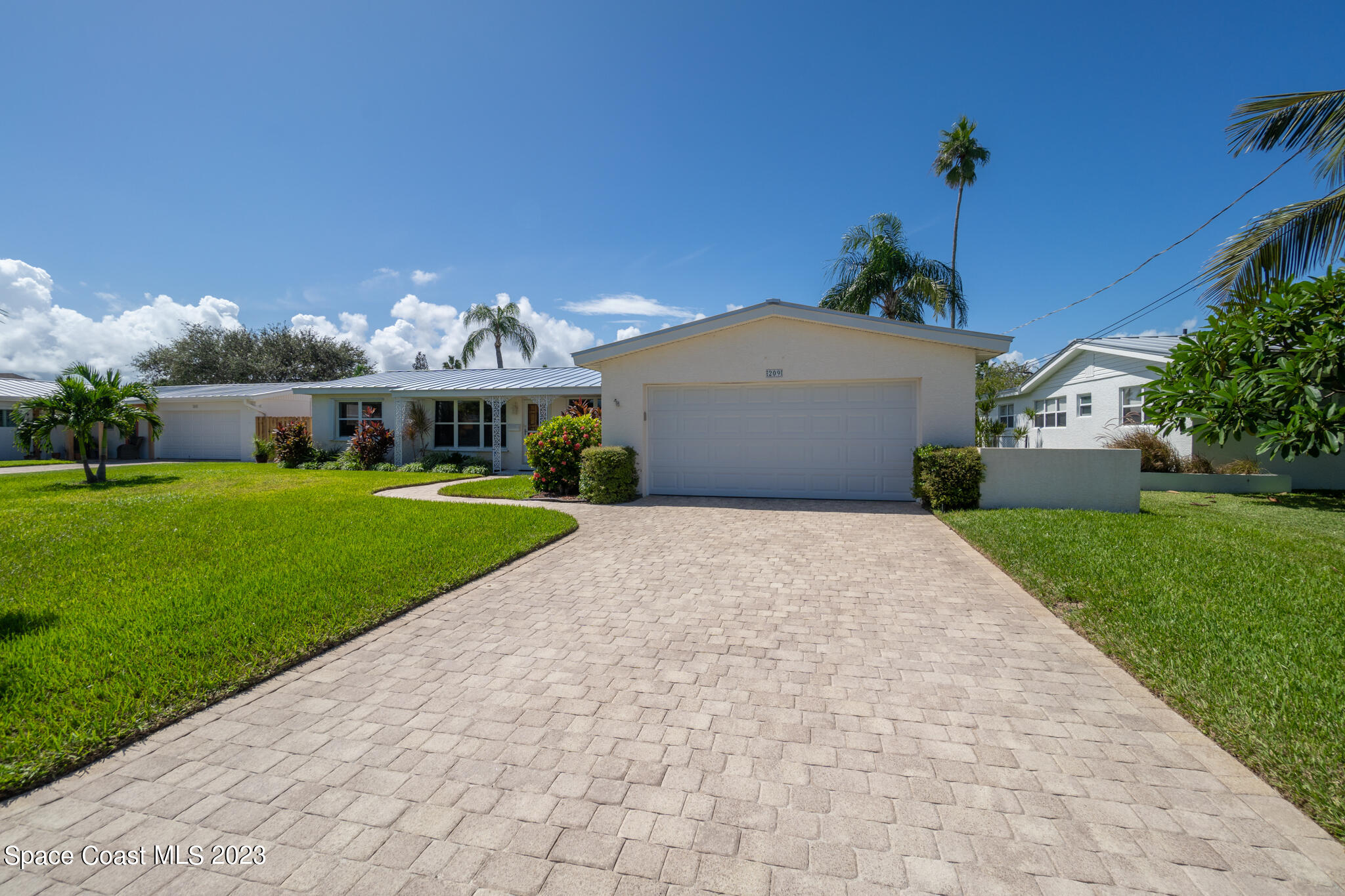 209 River Road Satellite Beach, FL 32937 - Photo 31 of 86 a front view of a house with a yard