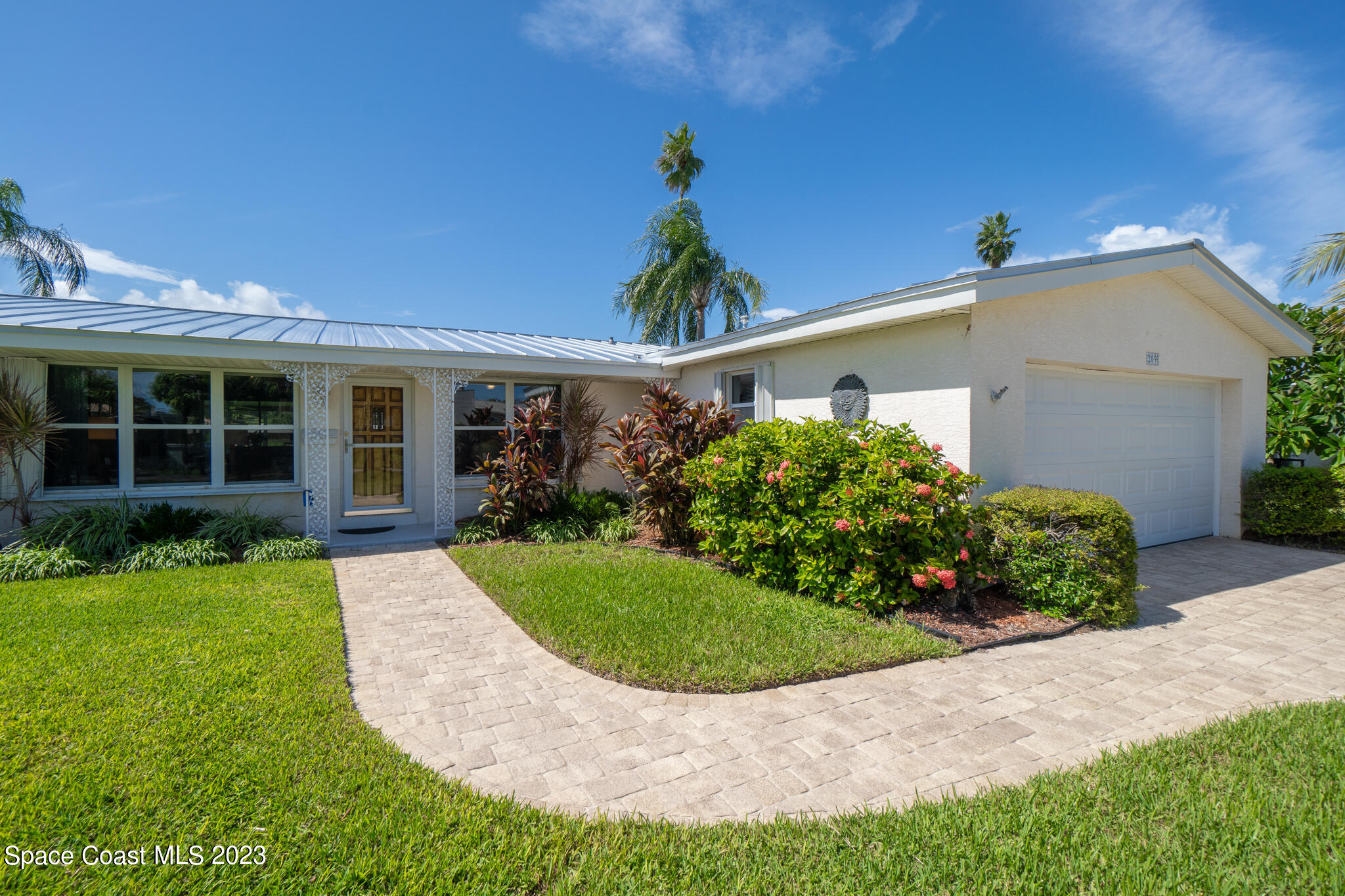 209 River Road Satellite Beach, FL 32937 - Photo 32 of 86 a front view of a house with a yard