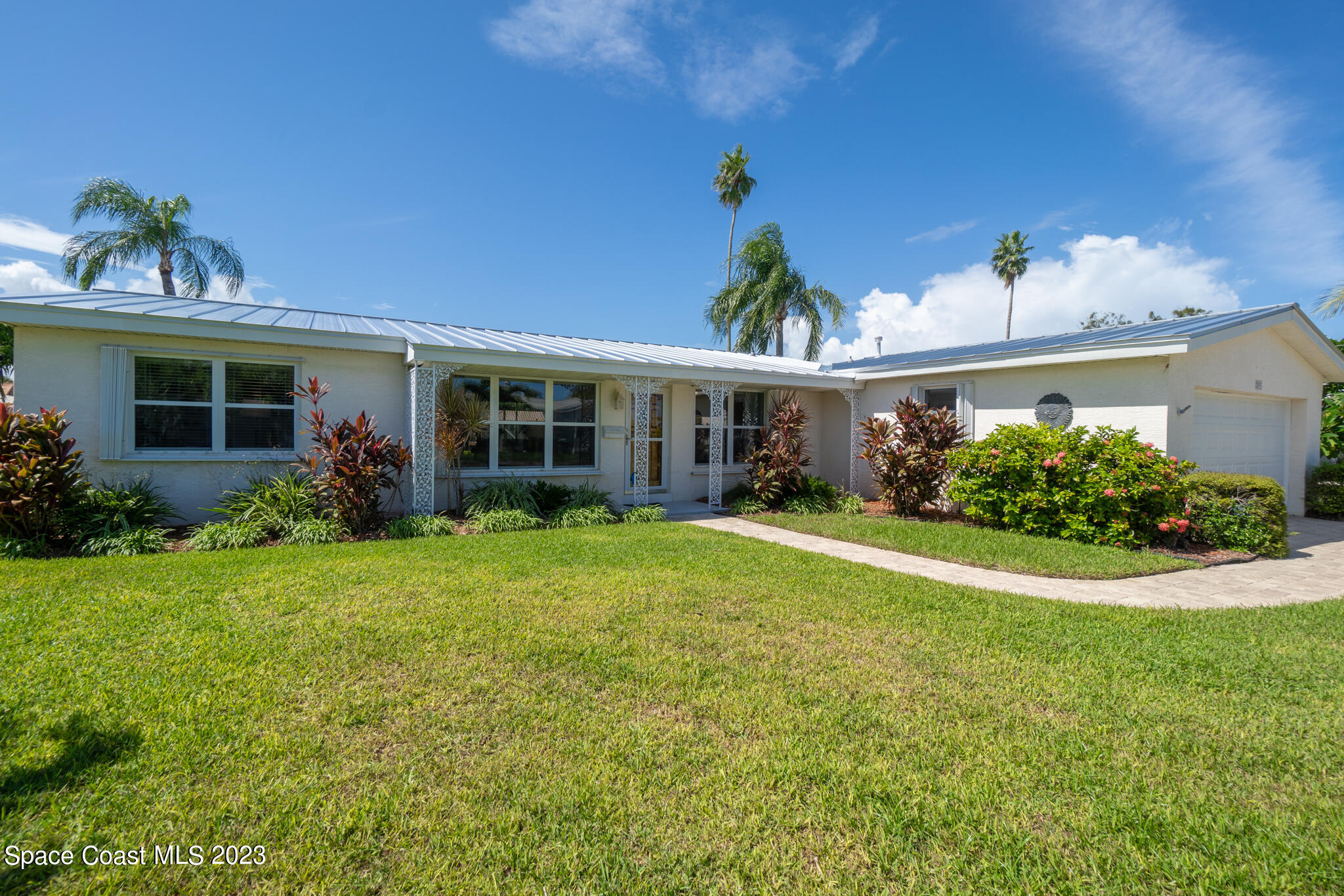 209 River Road Satellite Beach, FL 32937 - Photo 35 of 86 a view of a house with a yard and potted plants