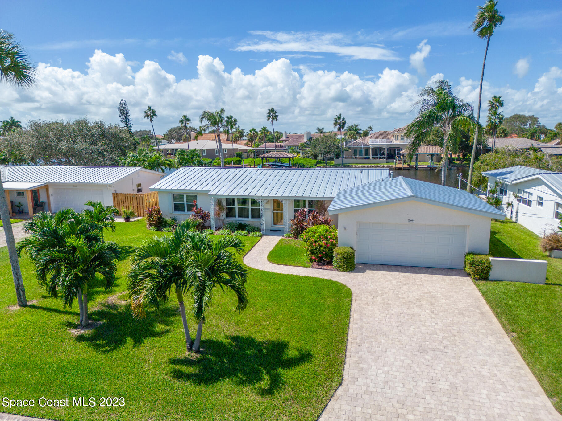209 River Road Satellite Beach, FL 32937 - Photo 52 of 86 a view of a house with a yard and potted plants