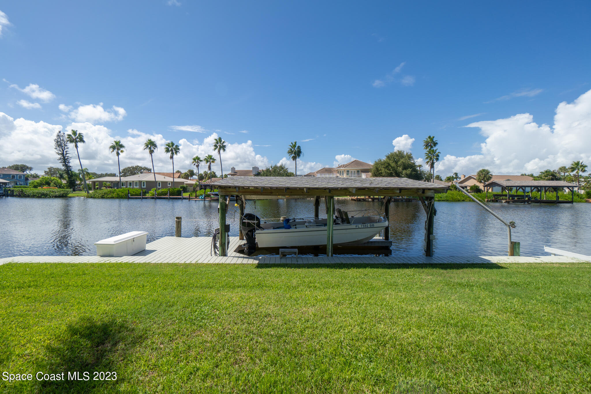 209 River Road Satellite Beach, FL 32937 - Photo 6 of 86 a front view of a house with garden and lake view