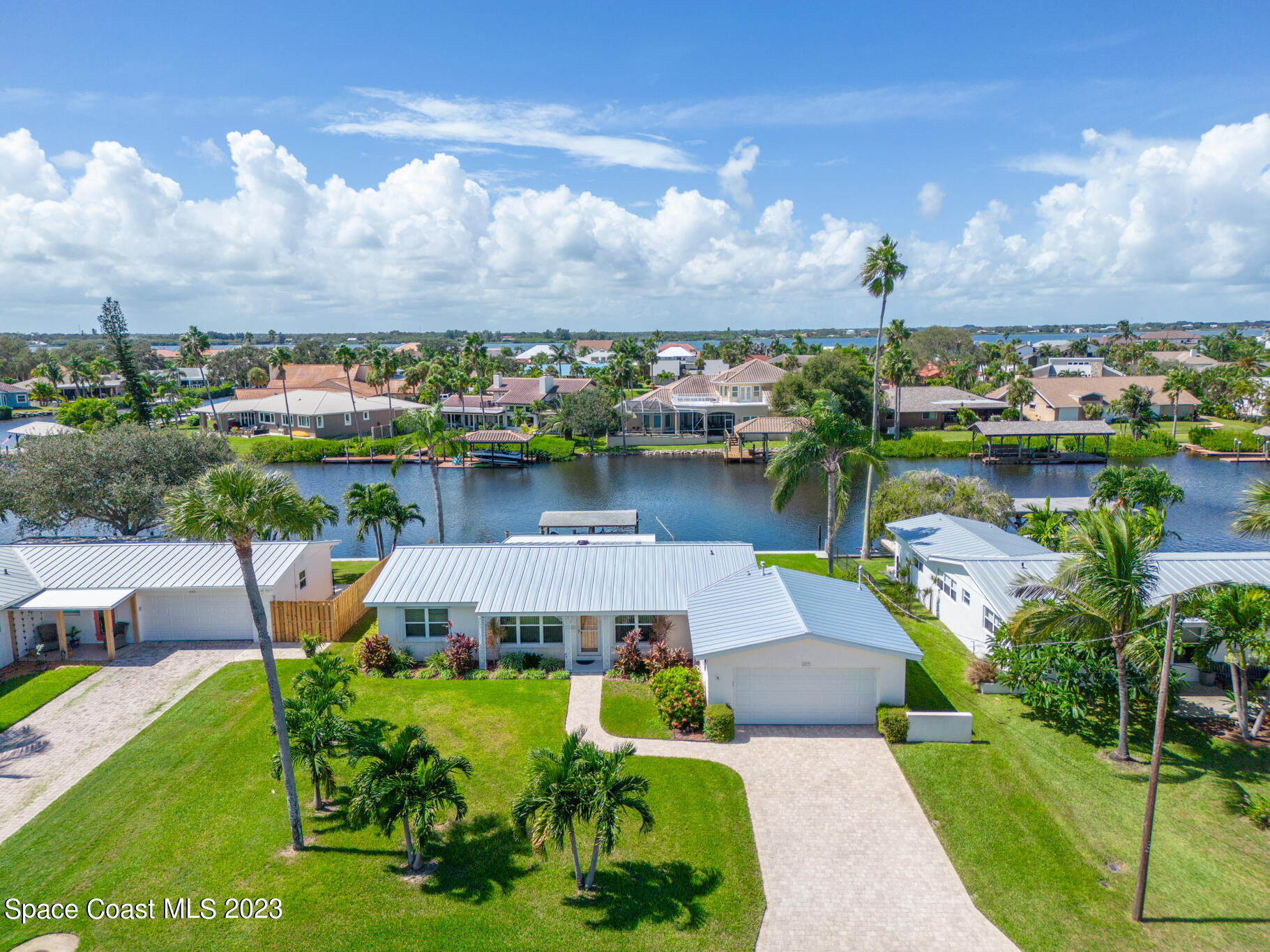 209 River Road Satellite Beach, FL 32937 - Photo 7 of 86 an aerial view of a house with swimming pool garden and lake view