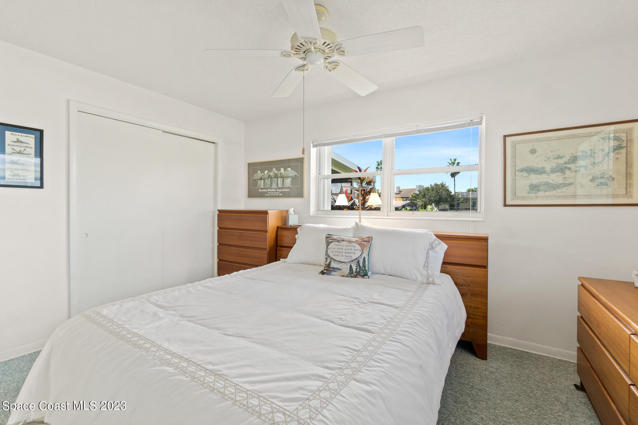 209 River Road Satellite Beach, FL 32937 - Photo 78 of 86 a bedroom with a bed and a painting on the wall