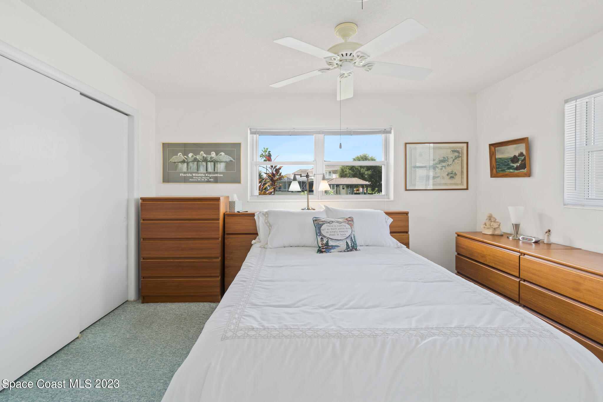 209 River Road Satellite Beach, FL 32937 - Photo 80 of 86 a bedroom with a large bed and a chandelier