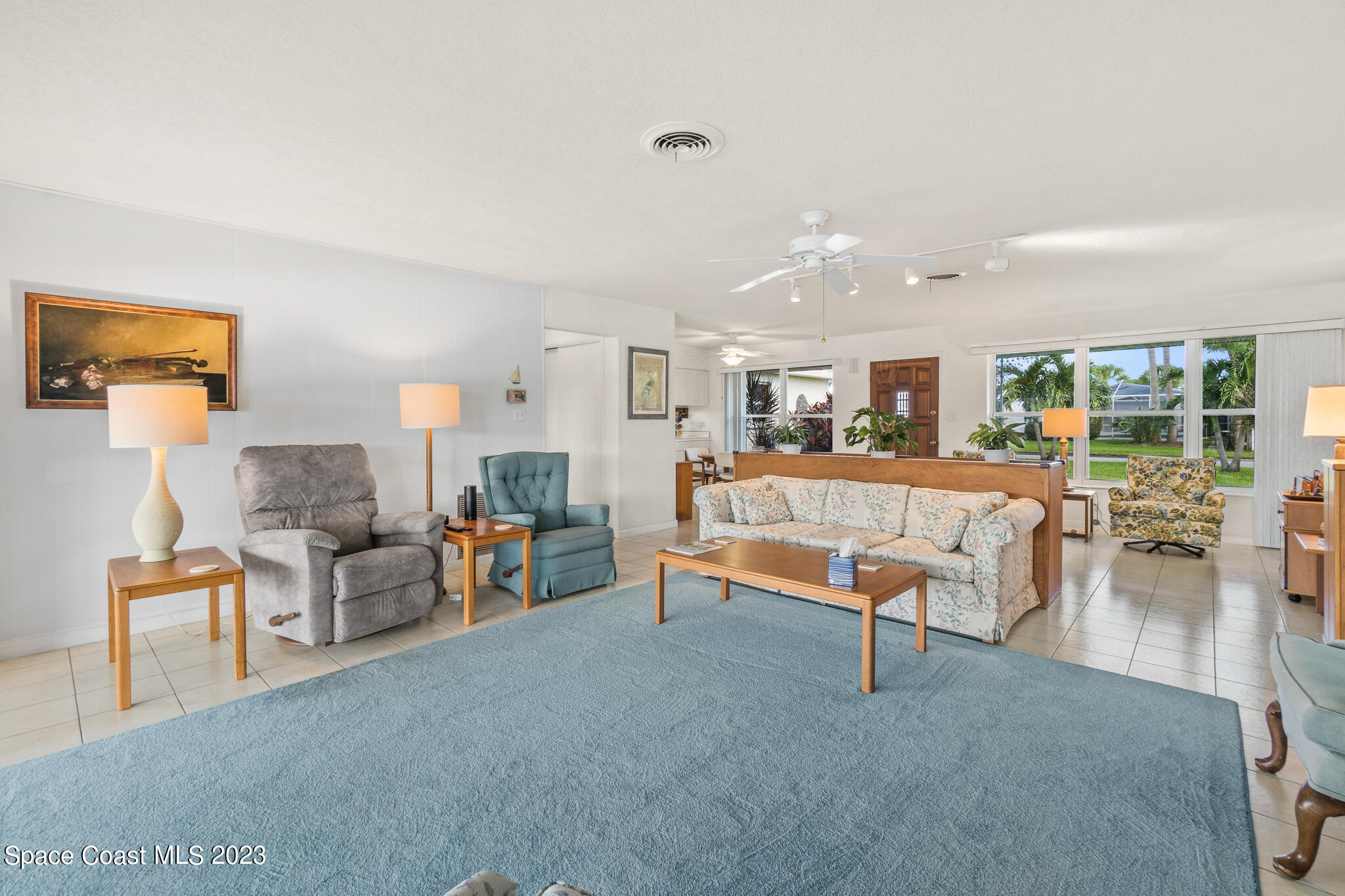 209 River Road Satellite Beach, FL 32937 - Photo 84 of 86 a living room with furniture and a dining table with wooden floor