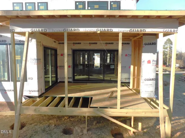 a bedroom with furniture and a large window