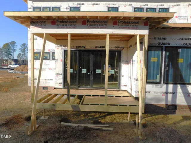 a living room with furniture a flat screen tv and a large window