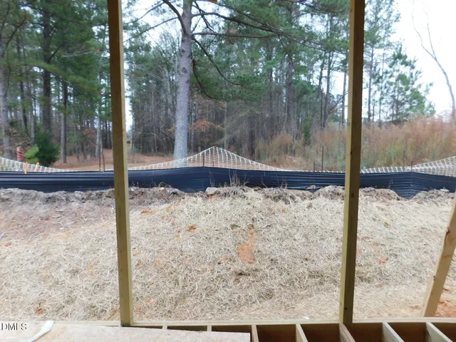 a view of an empty room with large windows