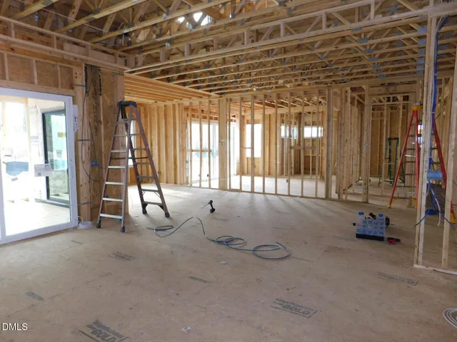 a view of a room with wooden floor and windows