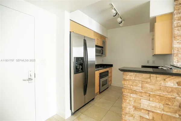 a bathroom with a granite countertop sink a mirror and a shower