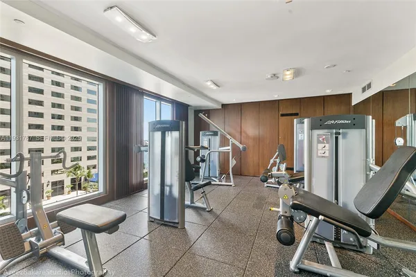 a bathroom with a granite countertop shower a mirror and a sink