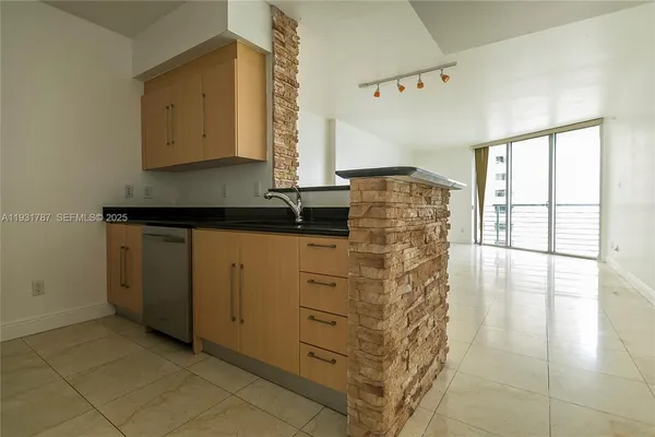 a spacious bathroom with a granite countertop sink a mirror and a bathtub