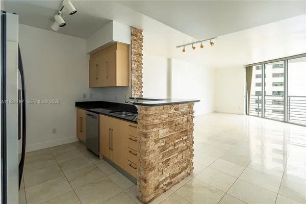 a kitchen that has a sink and a stove in it