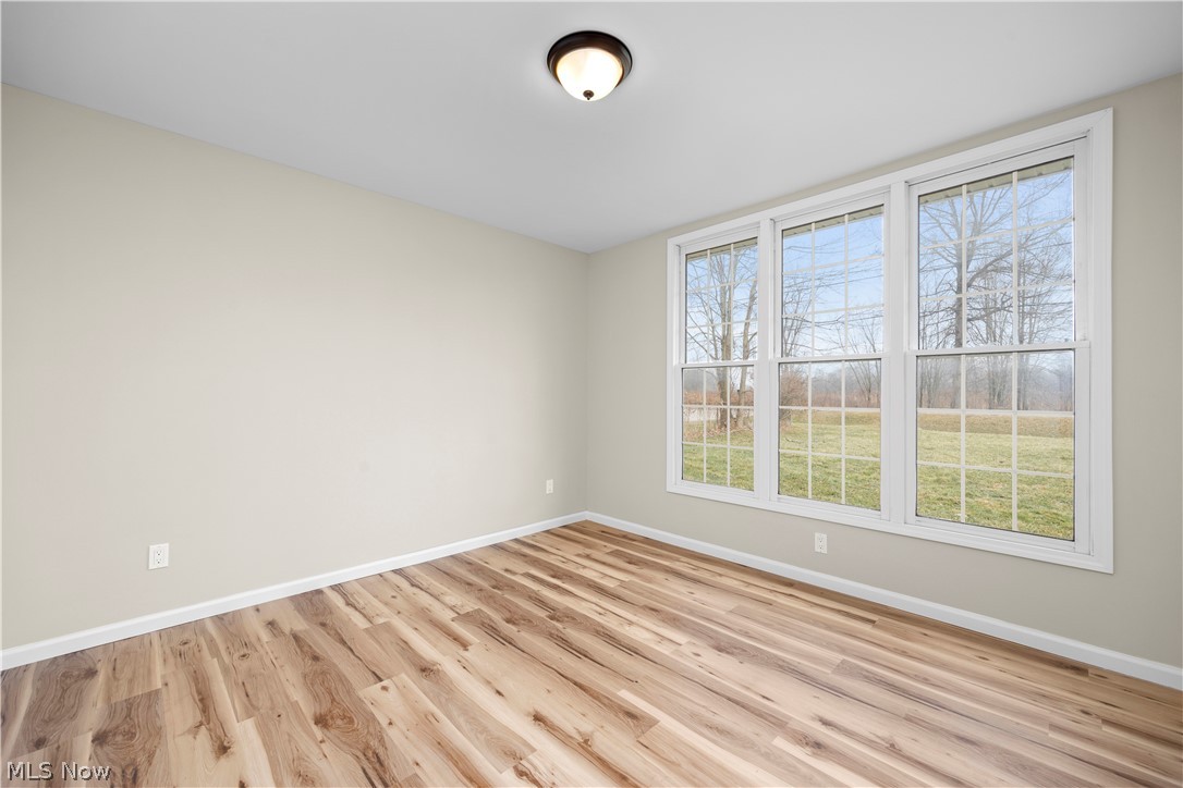 12452 Island Road Grafton, OH 44044 - Photo 17 of 39 Empty room featuring baseboards and light wood-style floors