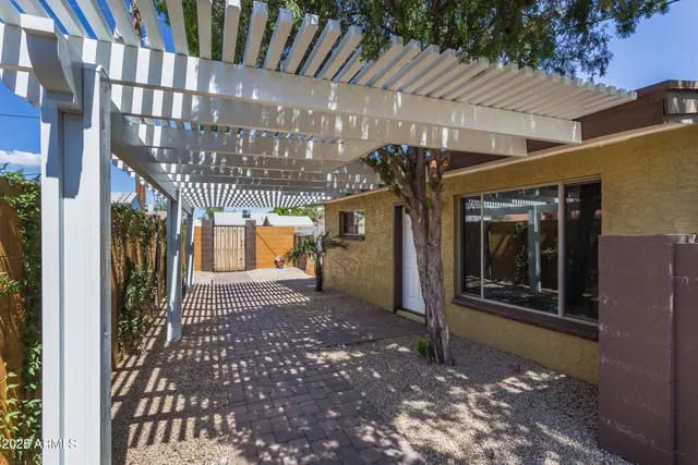 a view of a porch with a table and chairs