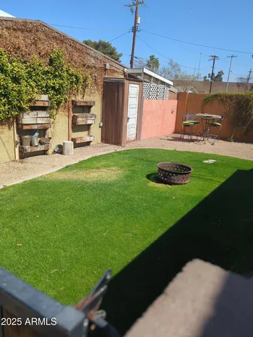 a view of a back yard of the house with a garden