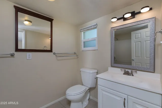 a bathroom with a toilet sink and mirror