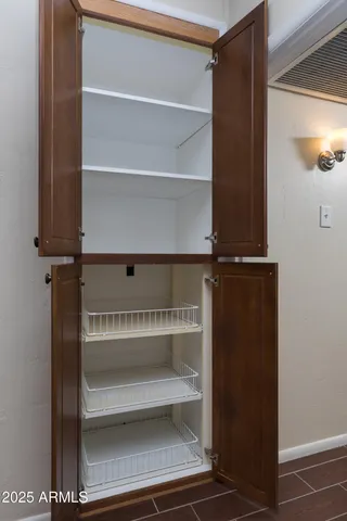 a view of walk in closet with empty racks