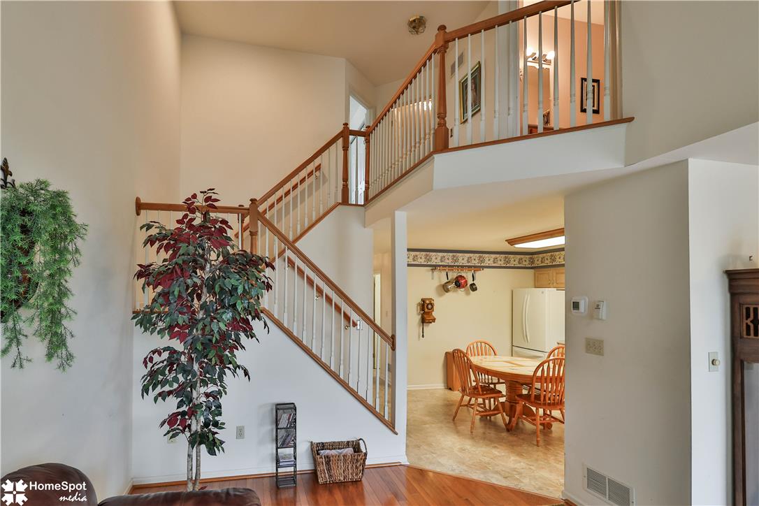507 Howertown Road Northampton, PA 18067 - Photo 46 of 46 An open concept floorplan connects the well-lit living area to the kitchen, accented by natural wood banisters.