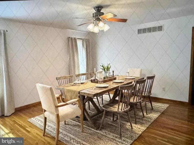 a view of a dining room with furniture and wooden floor