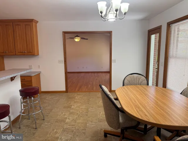 a view of a dining room with furniture and chandelier