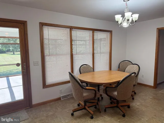 a dining room with furniture and window