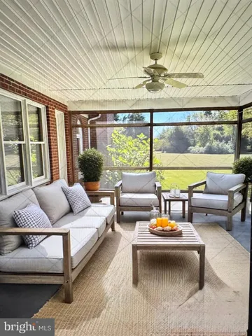 a bedroom with furniture and a large window