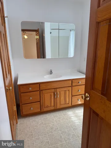 a bathroom with a sink a vanity and a mirror