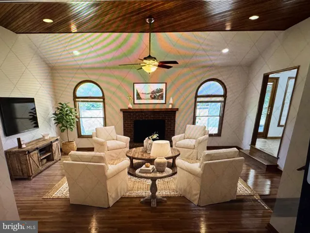 a living room with furniture a fireplace and a flat screen tv