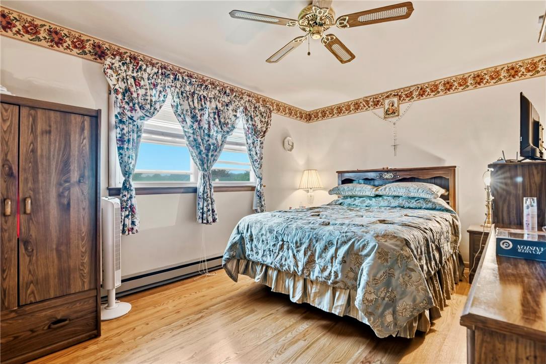 3303 Barklay Road Whitehall, PA 18052 - Photo 20 of 31 Hardwood floors and a ceiling fan create a comfortable atmosphere in this well-appointed bedroom.