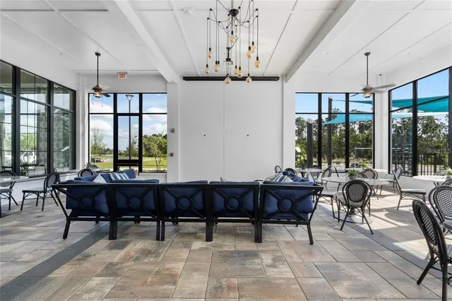a view of a dining room with furniture large windows and wooden floor