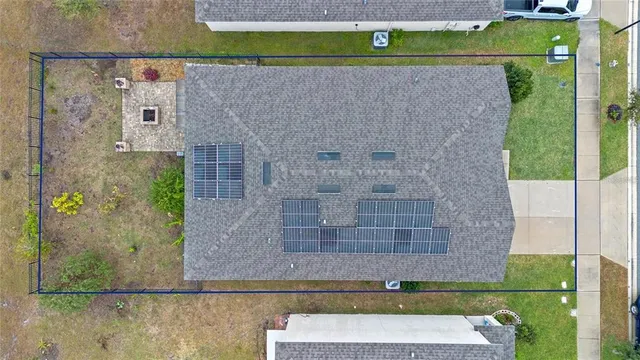a view of a patio with a table and chairs under an umbrella with a fire pit