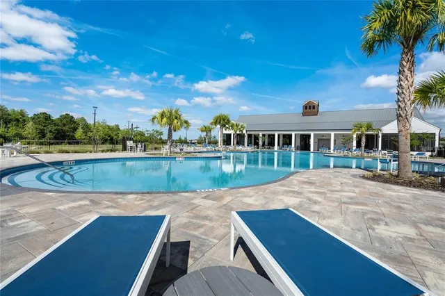 a view of a swimming pool with a yard