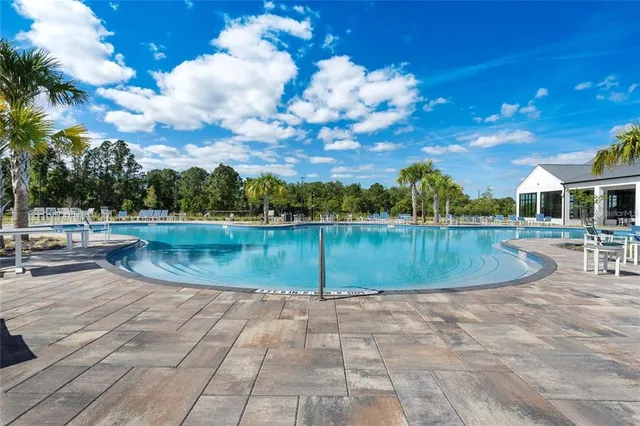 a roof deck with a couple of chairs