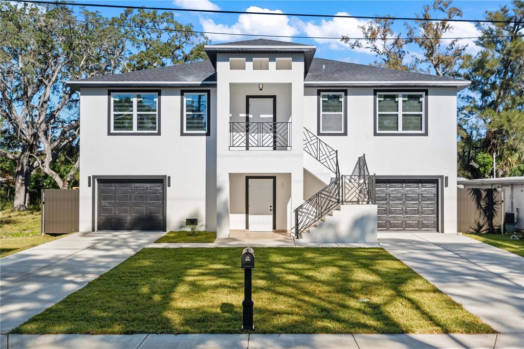 a view of a house with backyard and sitting area